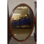EDWARDIAN OVAL OVERMANTEL MAHOGANY FRAMED MIRROR WITH STRUNG DECORATION, TOTAL SIZE APPROX 92 X