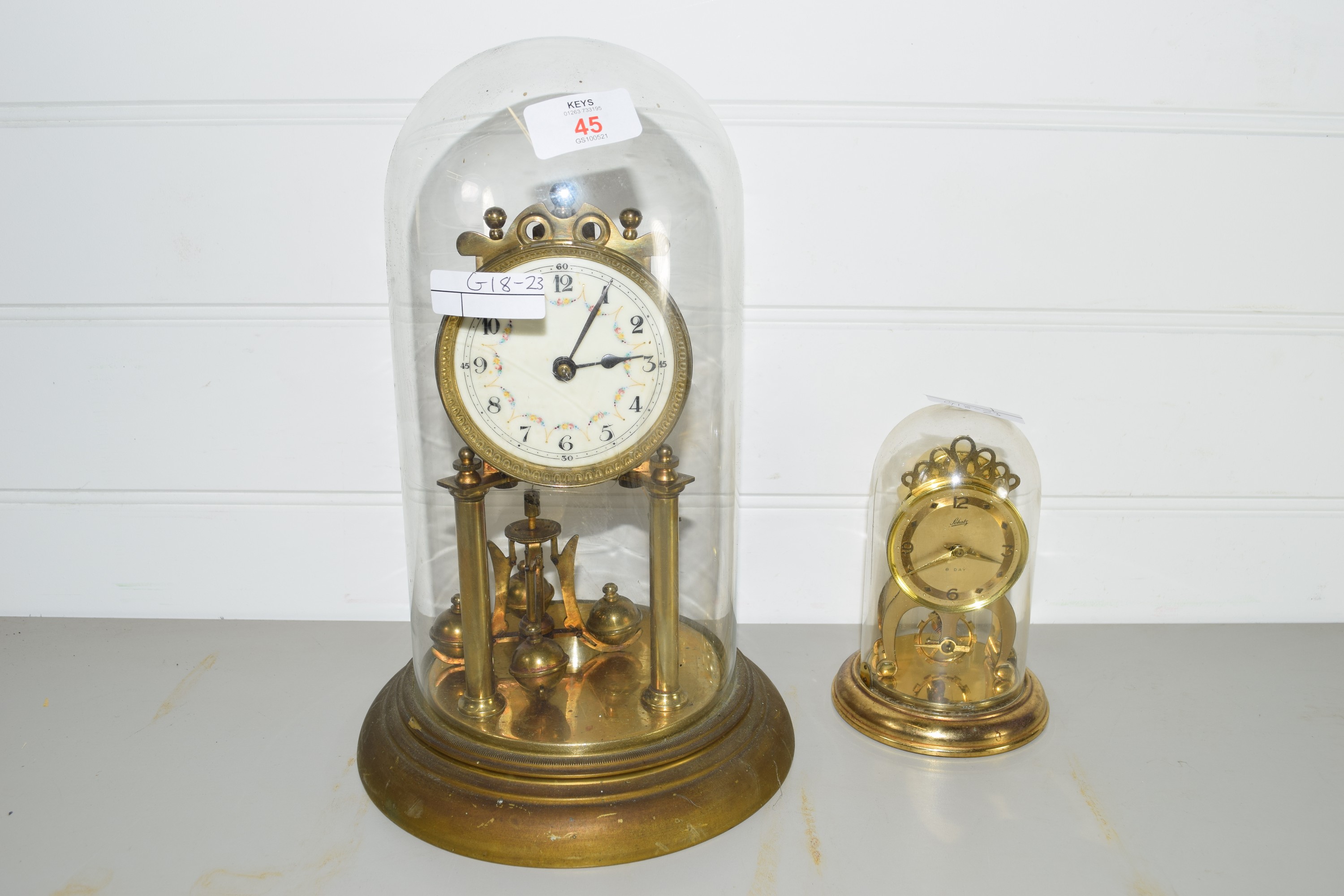 TWO CLOCKS IN GLASS DOMES