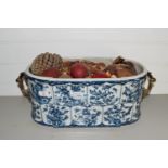 POTTERY BLUE AND WHITE DISH WITH METAL HANDLES CONTAINING PINECONES