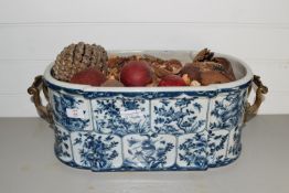 POTTERY BLUE AND WHITE DISH WITH METAL HANDLES CONTAINING PINECONES