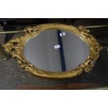 OVAL MIRROR WITH MOULDED GILT FRAME DEPICTING CHERUBS AND SCROLL WORK, APPROX 46 X 70CM MAX