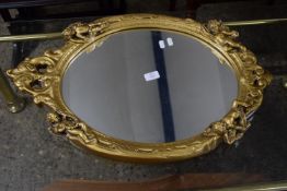 OVAL MIRROR WITH MOULDED GILT FRAME DEPICTING CHERUBS AND SCROLL WORK, APPROX 46 X 70CM MAX