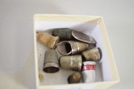 BOX OF SILVER METAL THIMBLES AND SMALL SILVER DISC