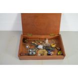 WOODEN BOX CONTAINING COSTUME JEWELLERY, ENAMEL BADGES, SMALL WRIST WATCH ETC