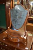 Edwardian shield-shaped toilet mirror raised on a serpentine three drawer base with ivory