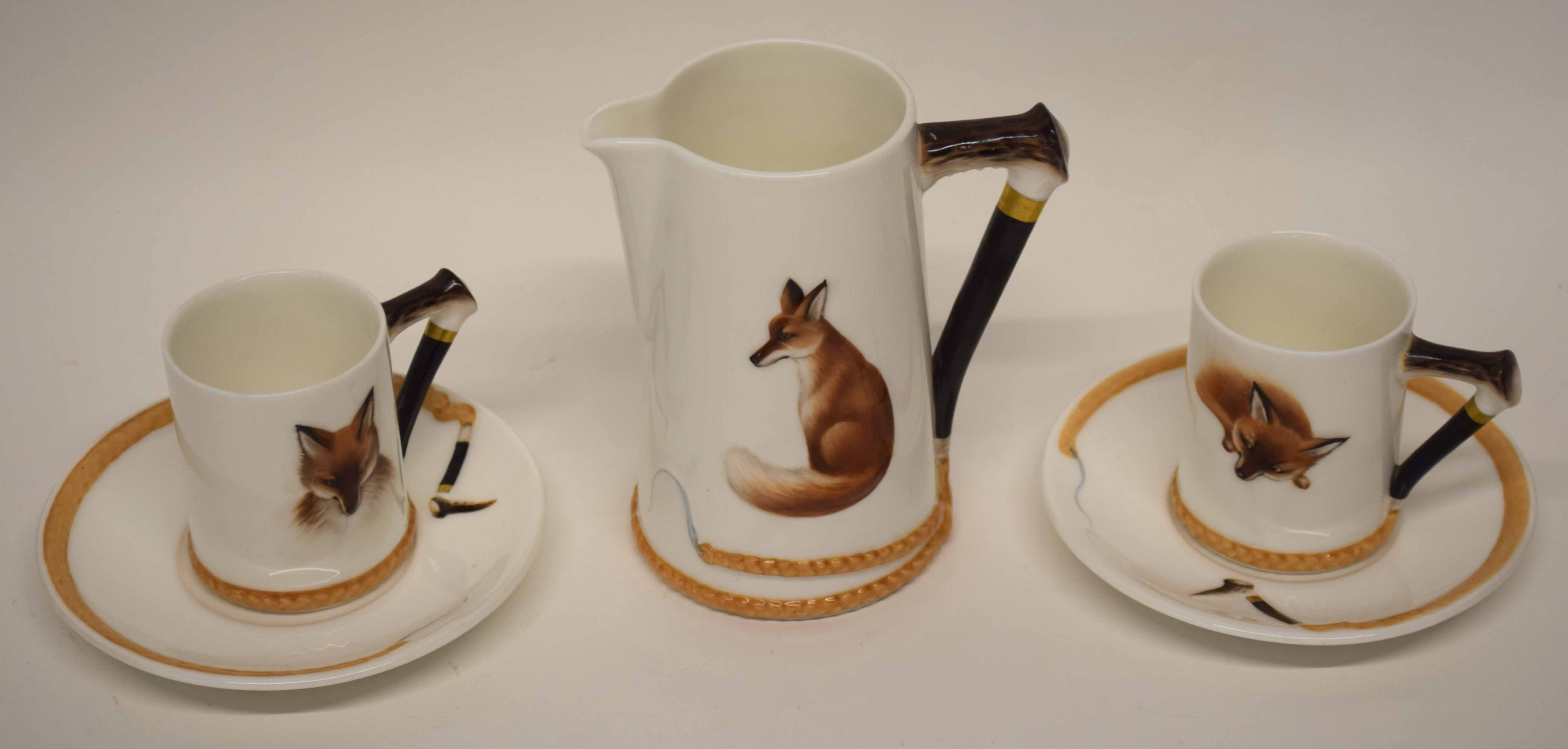 Two Royal Doulton fox hunting type coffee cups and saucers, together with a large jug, the handles