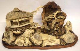 Intricate Japanese diorama depicting a mountainous landscape with pavilions and figures in wood,