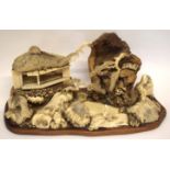 Intricate Japanese diorama depicting a mountainous landscape with pavilions and figures in wood,