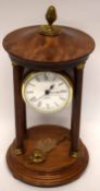 Quartz clock in wooden case, supported by four wooden pillars, with brass acorn knop, 27cm high