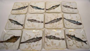 Quantity of Limoges plates, all of shaped design, decorated with fish amongst seaweed, picked out in