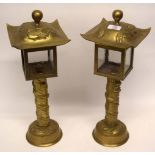 Pair of Oriental table lamps in brass, decorated with dragons in relief with brass covers, similarly