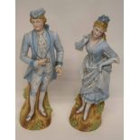 Late 19th century Continental figures of a gentleman and lady in bisque porcelain, painted in