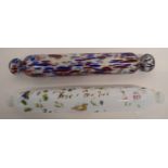 Two glass rolling pins, one with floral design with indistinct inscription, further pin with a