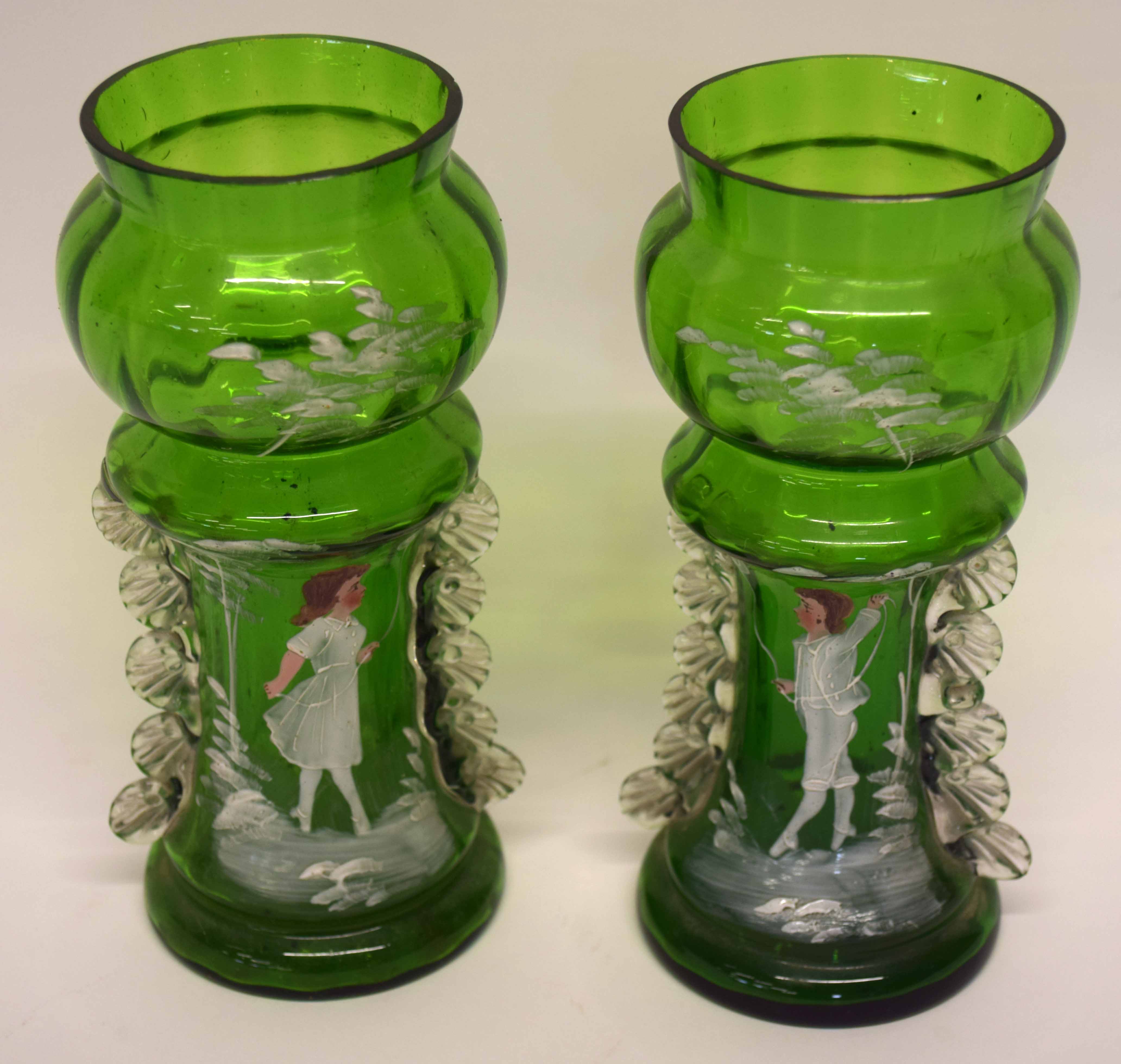 Two green glass vases, both painted with Mary Gregory type designs of children, (2), 18cm high