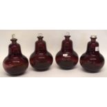 Group of four ruby coloured glass chemists jars, globular shape, with stoppers, (4)