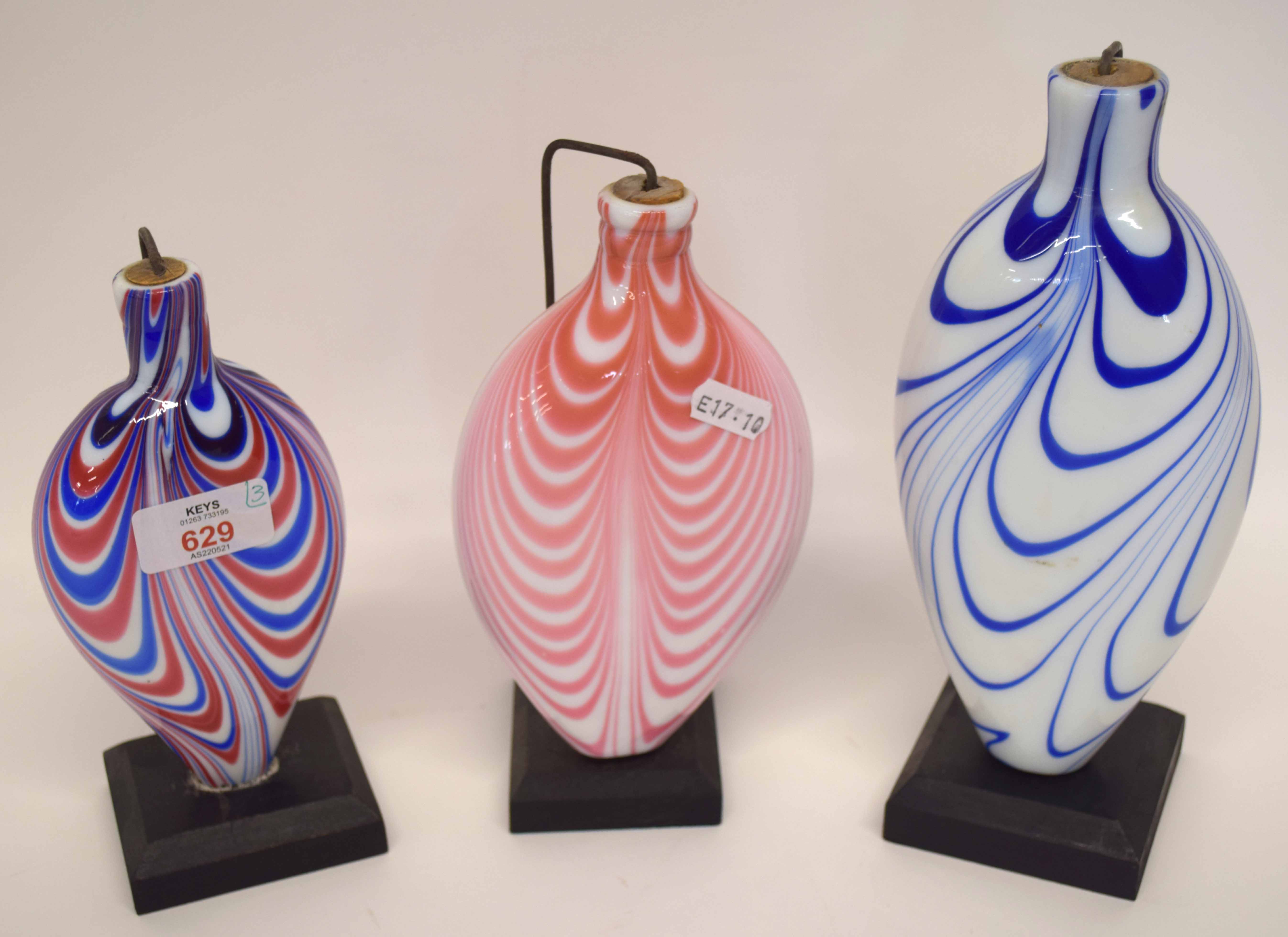 Three Nailsea type vases, all with coloured streaked designs, predominantly in blue and red, the