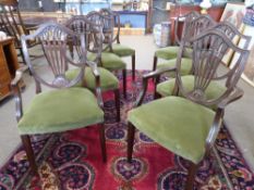 Set of 8 19th century shield back upholstered dining chairs with carved decoration.