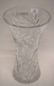 Large and heavy cut glass vase of flared form decorated with a floral pattern and star cut to