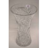 Large and heavy cut glass vase of flared form decorated with a floral pattern and star cut to