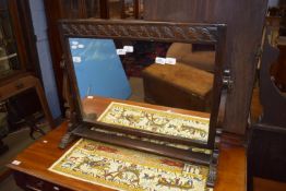 Decoratively carved oak swing mirror, 20th century, width approx 79cm max