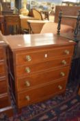 Small four drawer chest of panelled construction with circular brass handles and strung/cross banded