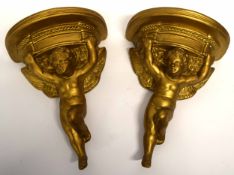 Two wooden wall brackets painted in gilt, of cherubs (2)