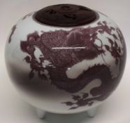 Large Oriental globular jar with wooden cover, the jar decorated with Imperial dragons in iron red