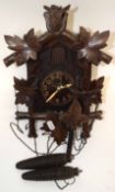 Early 20th century Black Forest cuckoo clock, case height max 31cm, typical decoration mounted