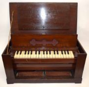Small wooden travelling harmonium with keyboard and foot pedals in wooden frame