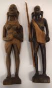 Pair of African carvings, one of a warrior holding a paddle, one of a woman, the pair 38cm high (2)