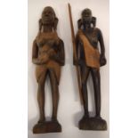 Pair of African carvings, one of a warrior holding a paddle, one of a woman, the pair 38cm high (2)