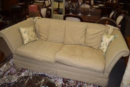 20th century Knole style two/three seater settee upholstered in beige fabric, having rope tied