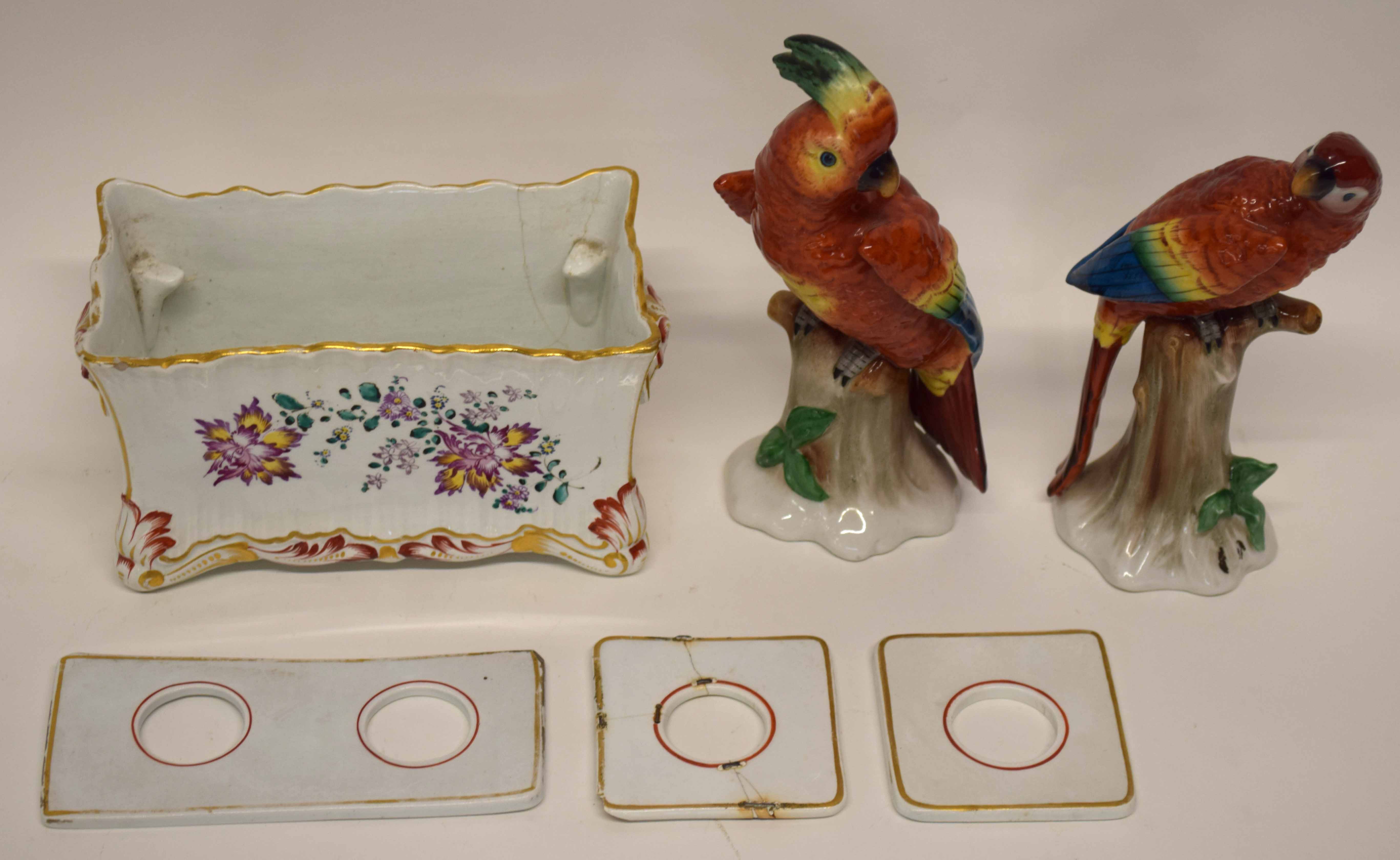 French Faience ink stand together with two Continental porcelain models of parrots on tree stumps,