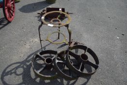 THREE CAST WHEELS TOGETHER WITH A TRIVET ETC