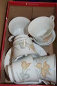 BOX CONTAINING WHITE AND BROWN FLORAL DECORATED CUPS AND SAUCERS