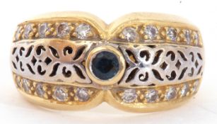 Two-tone yellow metal filigree fronted design ring, centring a small sapphire and highlighted with