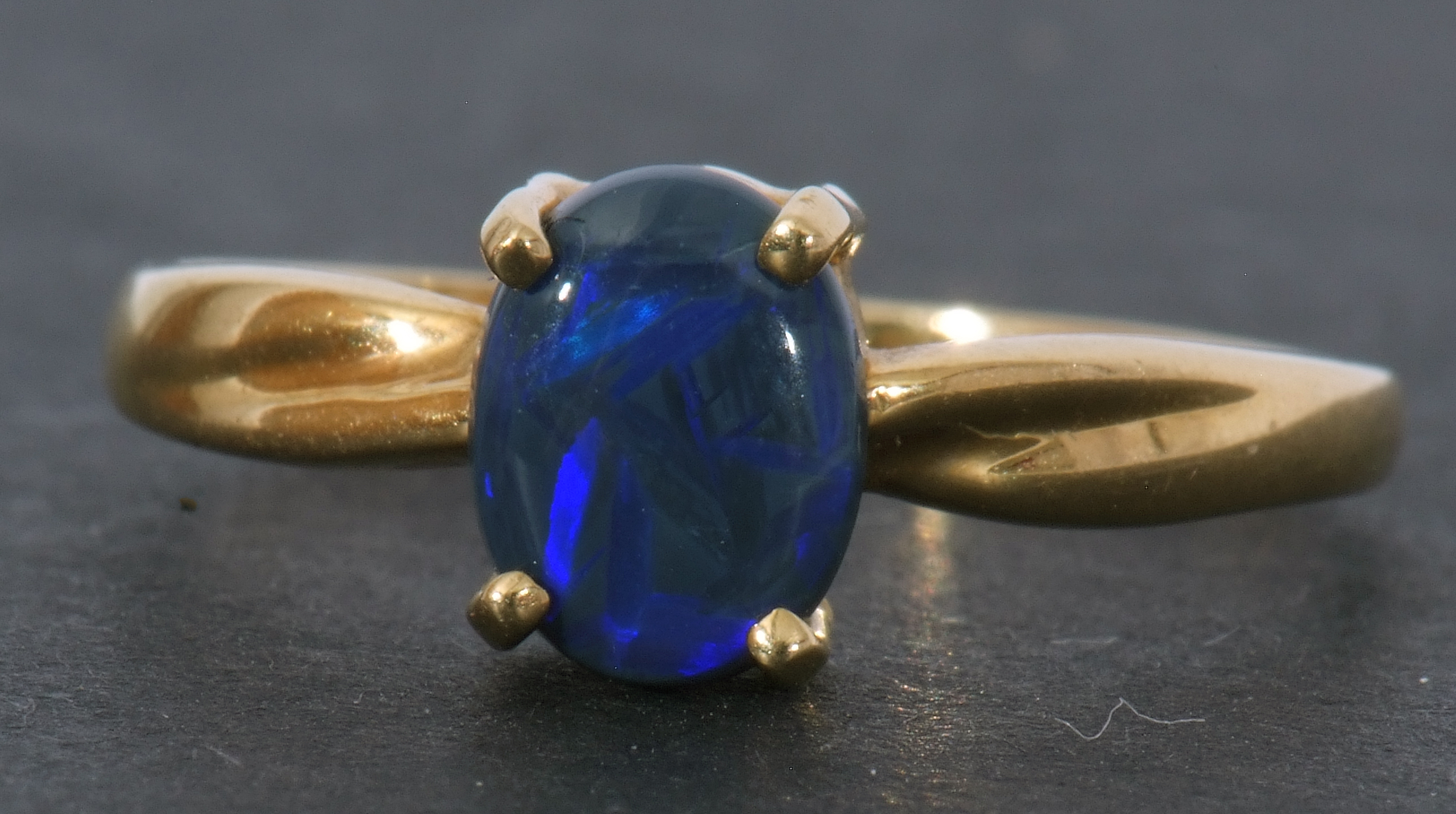 Modern black opal doublet ring, the oval shaped opal is four claw set and raised in a plain polished - Image 8 of 8