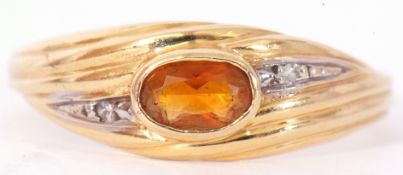 Modern 750 stamped citrine and diamond set ring centring an oval faceted cognac citrine in a rub-