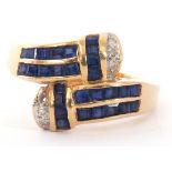 Modern sapphire and diamond cross over ring, each shoulder with 14 small calibre cut sapphires, pave