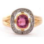 Ruby and diamond cluster ring, the bezel set cushion cut pale ruby within a small diamond