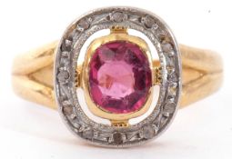 Ruby and diamond cluster ring, the bezel set cushion cut pale ruby within a small diamond