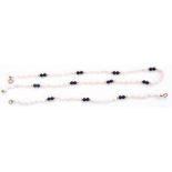 Matching necklace and bracelet of white freshwater cultured pearls interspersed by pairs of black