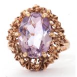 Vintage 9ct gold purple stone dress ring, the oval cut faceted purple stone in a pierced bead