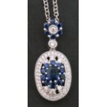 Modern sapphire and diamond pendant, the oval shaped pendant with central sapphire cluster, within a