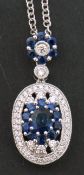 Modern sapphire and diamond pendant, the oval shaped pendant with central sapphire cluster, within a