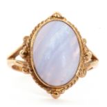 9ct gold and quartz ring, a cabochon centre pale quartz, bezel set and framed in a bead and split