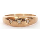 9ct gold and diamond gipsy style ring featuring three small diamonds, each in star engraved