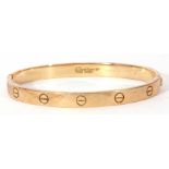 Cartier love bracelet, an oval design with screw motif displayed around the outer edge, the