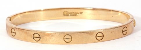 Cartier love bracelet, an oval design with screw motif displayed around the outer edge, the