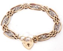 9ct two-tone gold bracelet of stylised oval links and mesh work joiners, to a heart shaped padlock